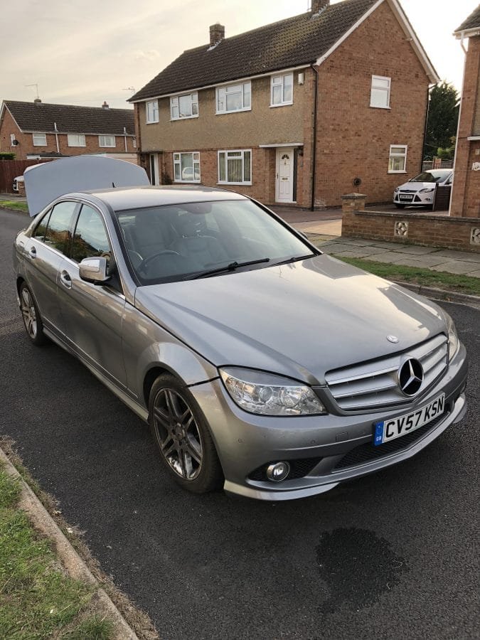Silver Mercedes parked on a residential street