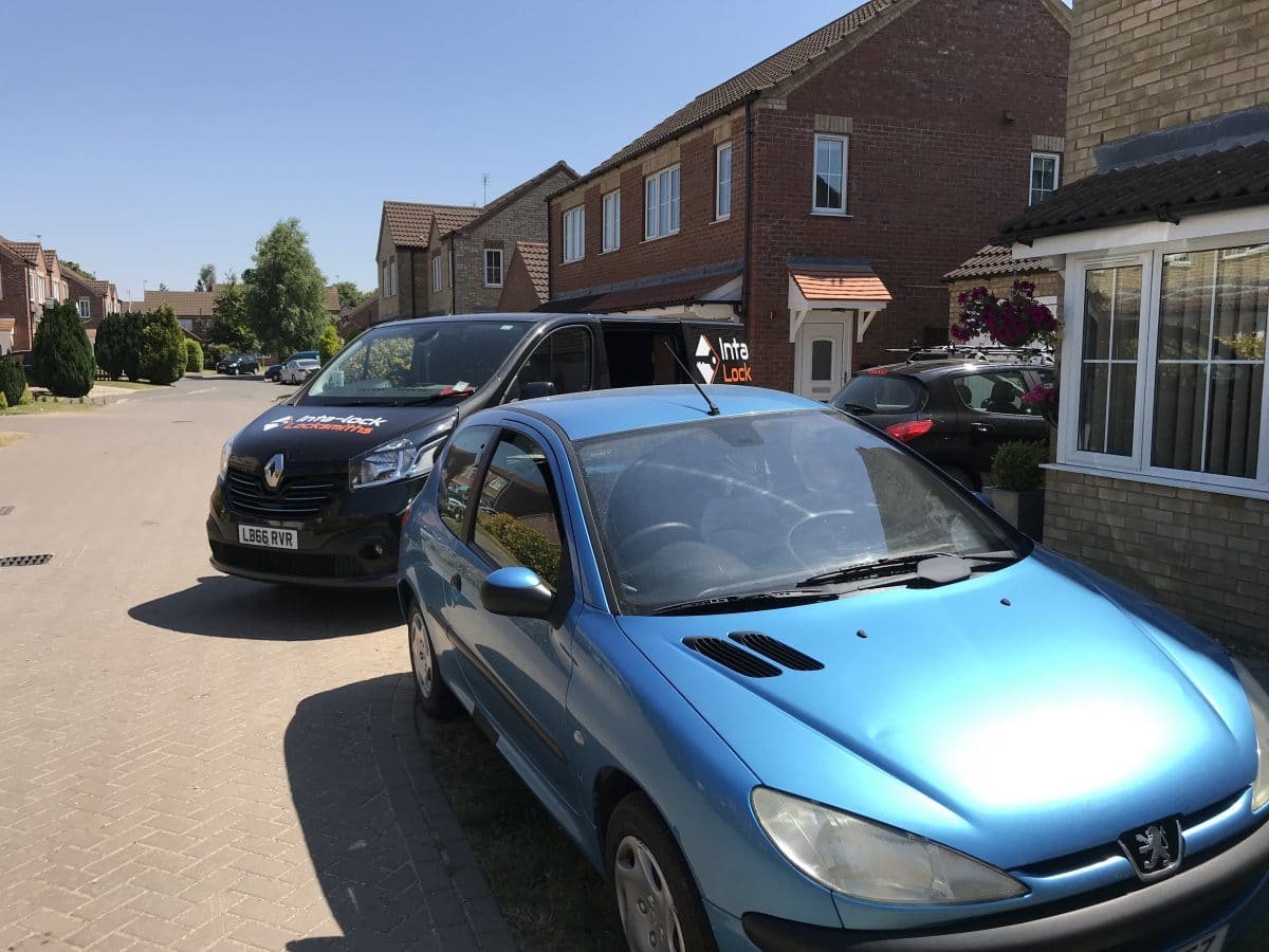 Blue Peugeot parked on a residential driveway
